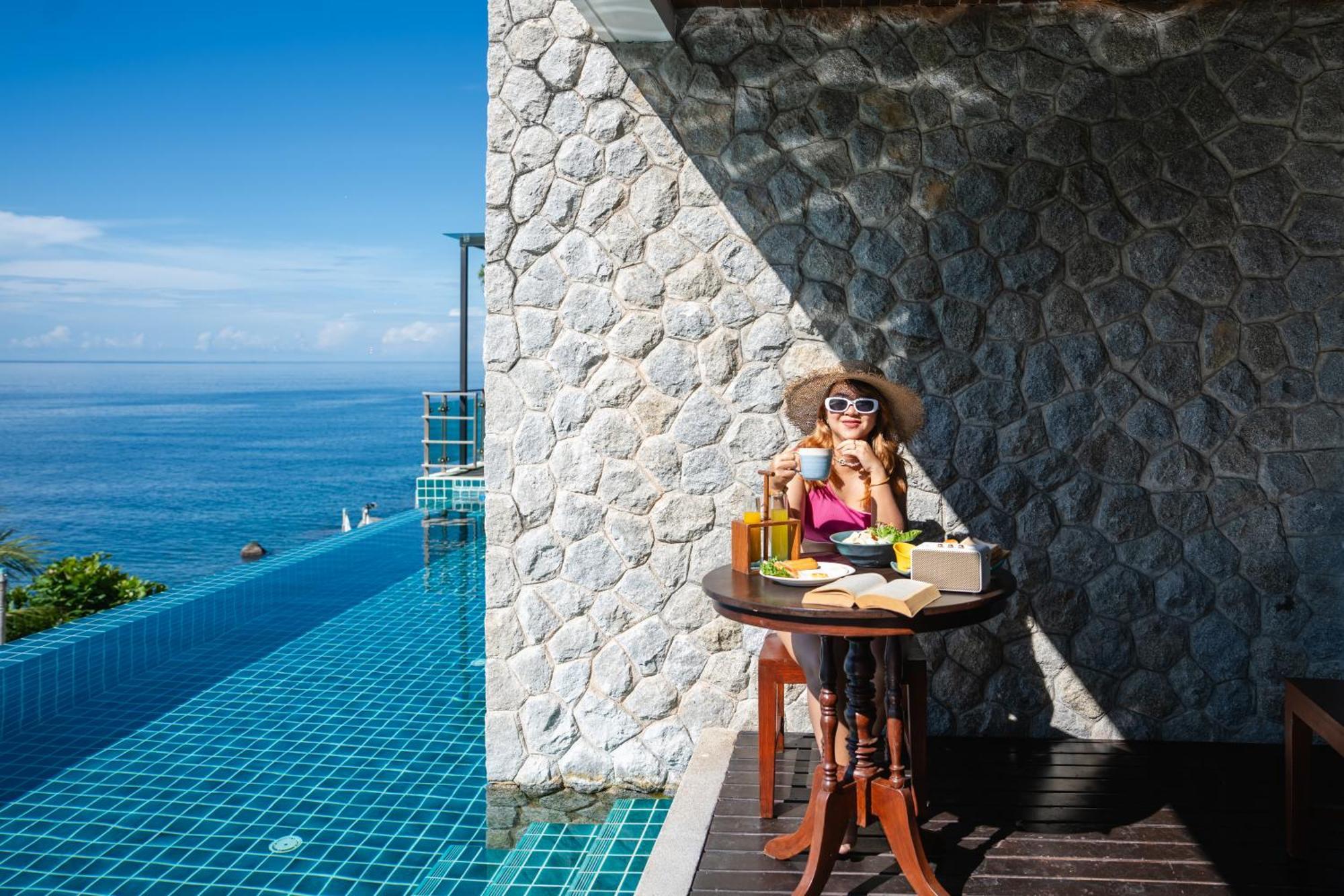 Zenmaya Oceanfront Phuket, Trademark Collection By Wyndham Patong Экстерьер фото A woman enjoying a morning coffee at the poolside of the resort